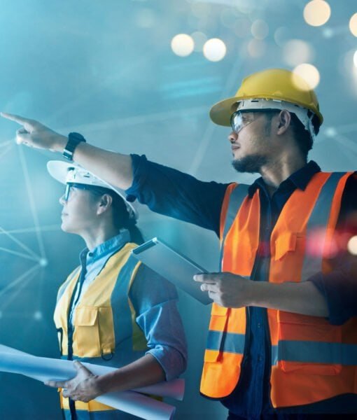 Male and female industrial engineers using tablet computer and b